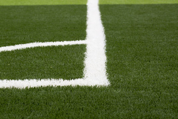A closeup photo taken on a football field line paint marking.