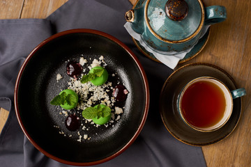 Delicious restaurant dessert from apples, chocolate, mint and caramel glazed in form of small apples with leafs. Top view or flat lay