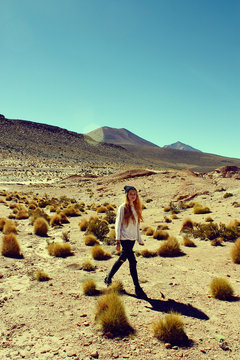 young skinny woman walking in Andean highlands, Bolivia