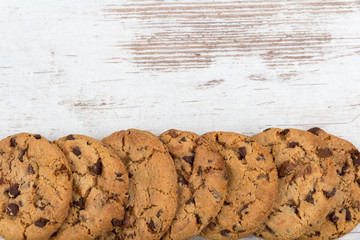 chocolate cookies on white wooden background