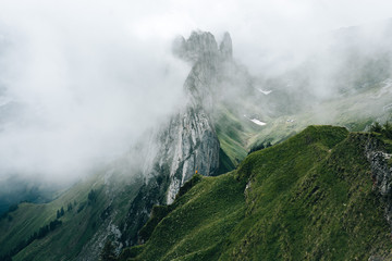 single person standing in front of a massive mountain in Switzerland
