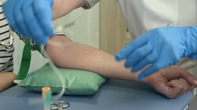 Nurse collecting blood from patient vein