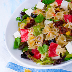 Mediterranean Farfalle salad with dry tomatoes and pine cores