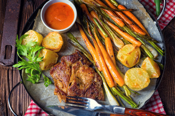 Grilled steak with vegetables and fried potatoes