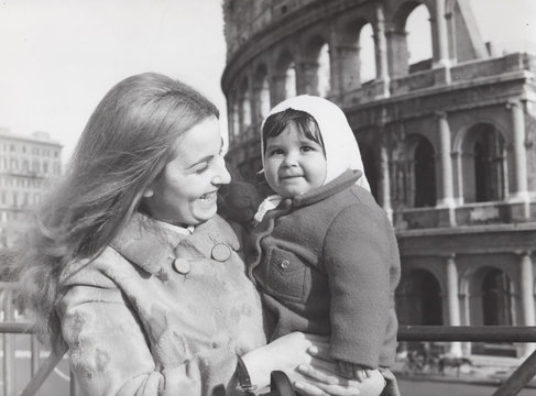 Madre con figlia piccola davanti al Colosseo negli anni settanta