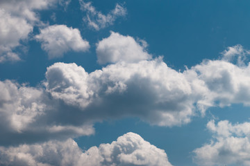 White clouds on a blue sky. The blue sky