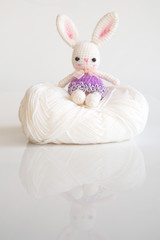 Handmade crochet doll. Cute rabbit doll on white background. Creative gift. Handcraft toy.