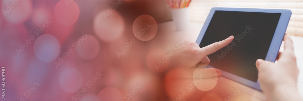 Poster hand touching tablet with red bokeh transition
