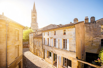 Street view in Saint Emilion village with church tower during the sunset in France