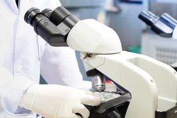 Scientist hands with microscope, examining samples and liquid. Medical research with technical equipment, Close-up of scientist hands with microscope.