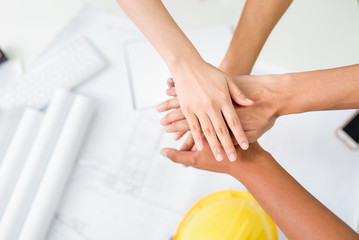 Close up group of Construction engineer,worker,foreman,Project Engineer and owner  shake up their hand after achieve their mission or construction.