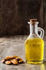 Almond oil in bottle on wooden table

