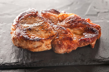 fried pork steak on a black stone