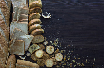 Pile of expire breads on dark wooden background / Still life image and selective focus and space...