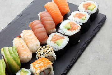 close up of sashimi sushi set with chopsticks and soy - sushi roll with salmon and sushi roll with smoked eel, selective focus.