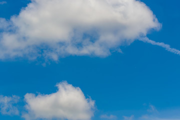 The sky is a small cloud floating in the sky.