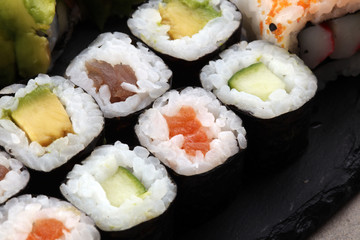 close up of sashimi sushi set with chopsticks and soy - sushi roll with salmon and sushi roll with smoked eel, selective focus.