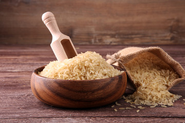 rice, indian basmati, pakistani basmati uncooked on brown background