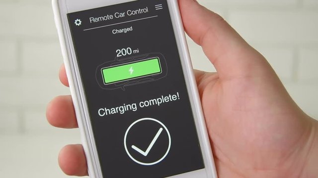 Man checks charge level of his electric car. Battery is charged. Car remote control using smartphone application fictional interface.
