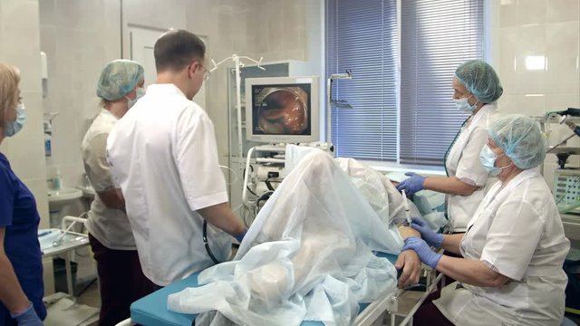 Doctors conducting procedure in endoscopy room