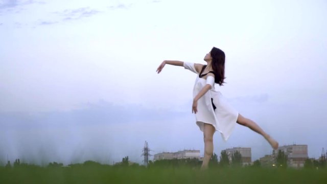 Japanese girl in white dress dancing ballet, slow motion