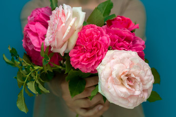 girl holding a bouquet of beautiful pink fluffy roses