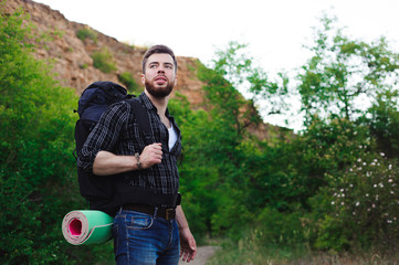 Naklejka premium Young Man Traveler with backpack relaxing outdoor. Summer vacations and Lifestyle hiking concept