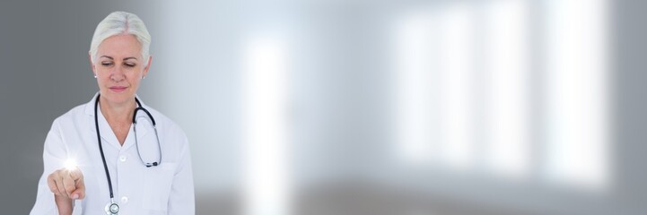 Doctor pointing against blurry white room