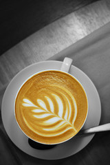 Latte art coffee in white cups placed on a gray wooden floor, Copy space