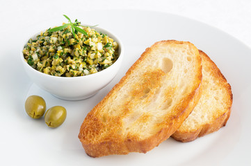 fried bread slices with paste of green olives and herbs