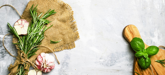 Food background, spicy herbs and garlic, top view