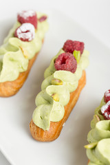 Eclair with pistachio cream and strawberries