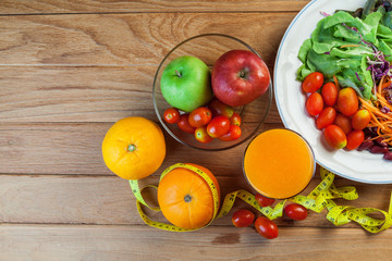 Healthy concept with mixed fruits and vegetables on wooden background