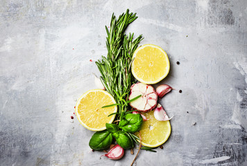 Food background, rosemary, garlic and lemon slice, top view