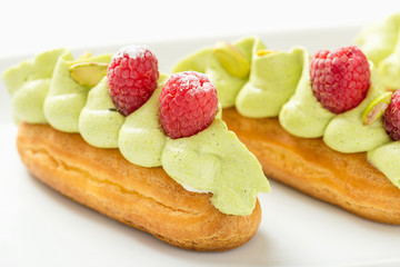 Eclair with pistachio cream and strawberries