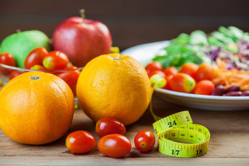 Healthy concept with mixed fruits and vegetables on wooden background