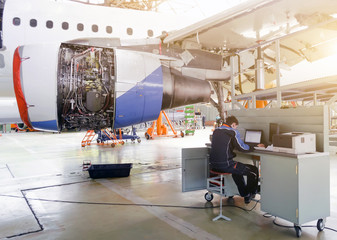 Aircraft service, view of the engine of the aircraft and with a technician at the computer