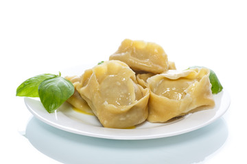 Boiled manti with meat on a plate