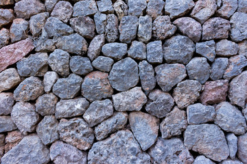 lot of blue grey stones stacked to a wall