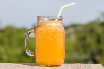 Smoothies from carrot, lemon, honey and banana in glass