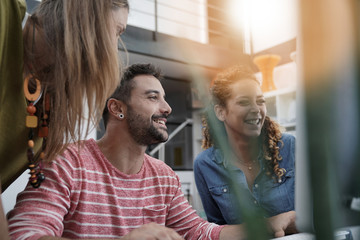 Start-up people working on desktop in co-working space