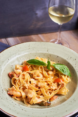 Tagliatelle with prawns and spices in tomato-cream sauce