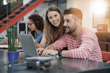 Start-up people working on laptop in office