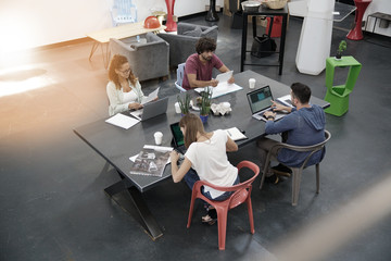 Upper view of start-up people working in open co-working office