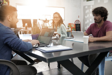 Trendy young people working in co-working office