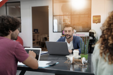 Trendy young people working in co-working office