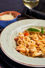 Tagliatelle with prawns and spices in tomato-cream sauce