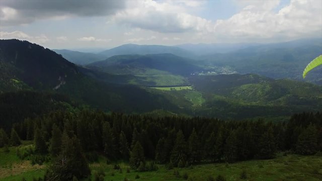 Aerial Paragliding over Mountains and Valleys