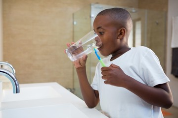 Fototapeta premium Boy drinking water from glass