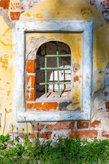 Fototapeta na wymiar Window's niche in an old abandoned non-residential building 